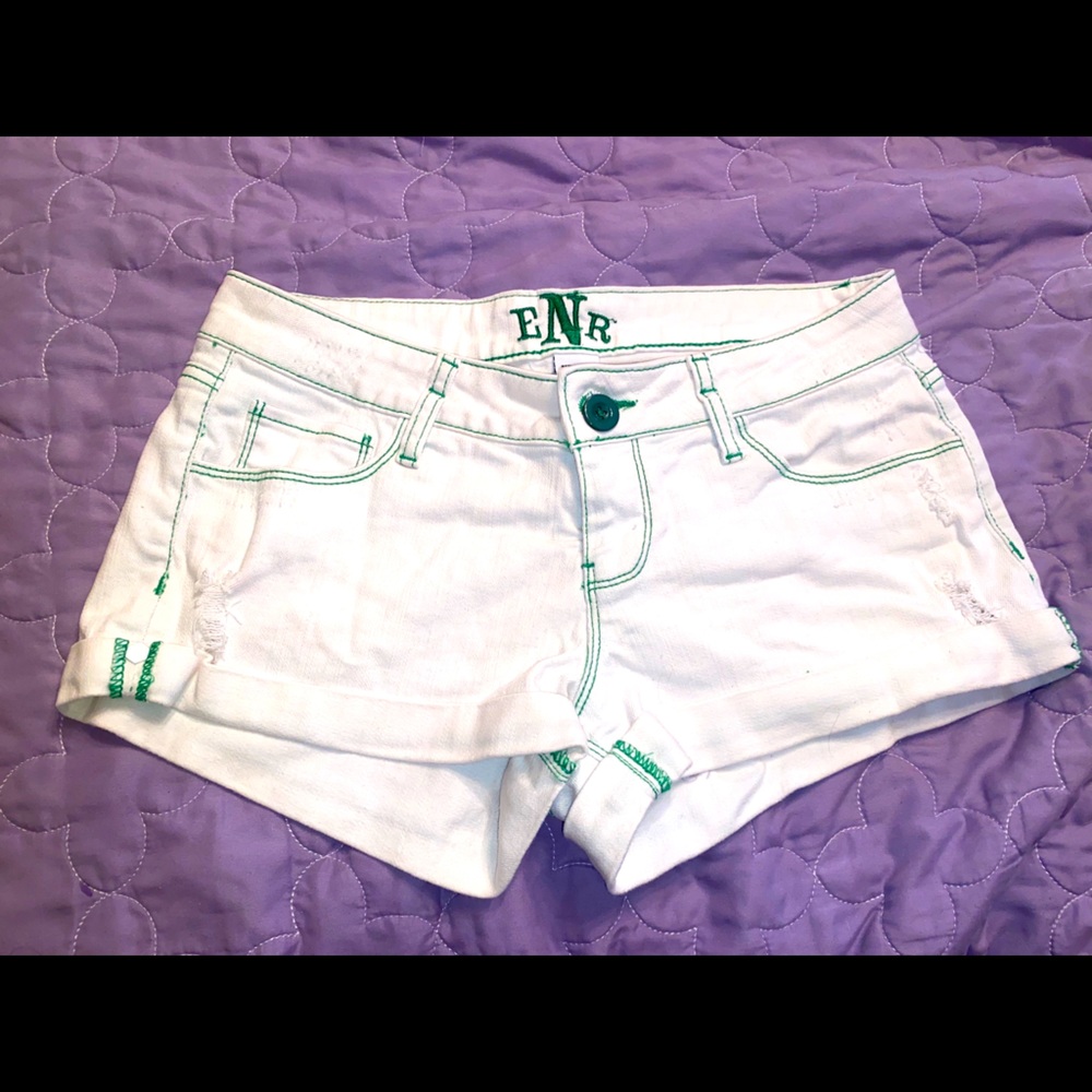 White denim shorts with green stitching
